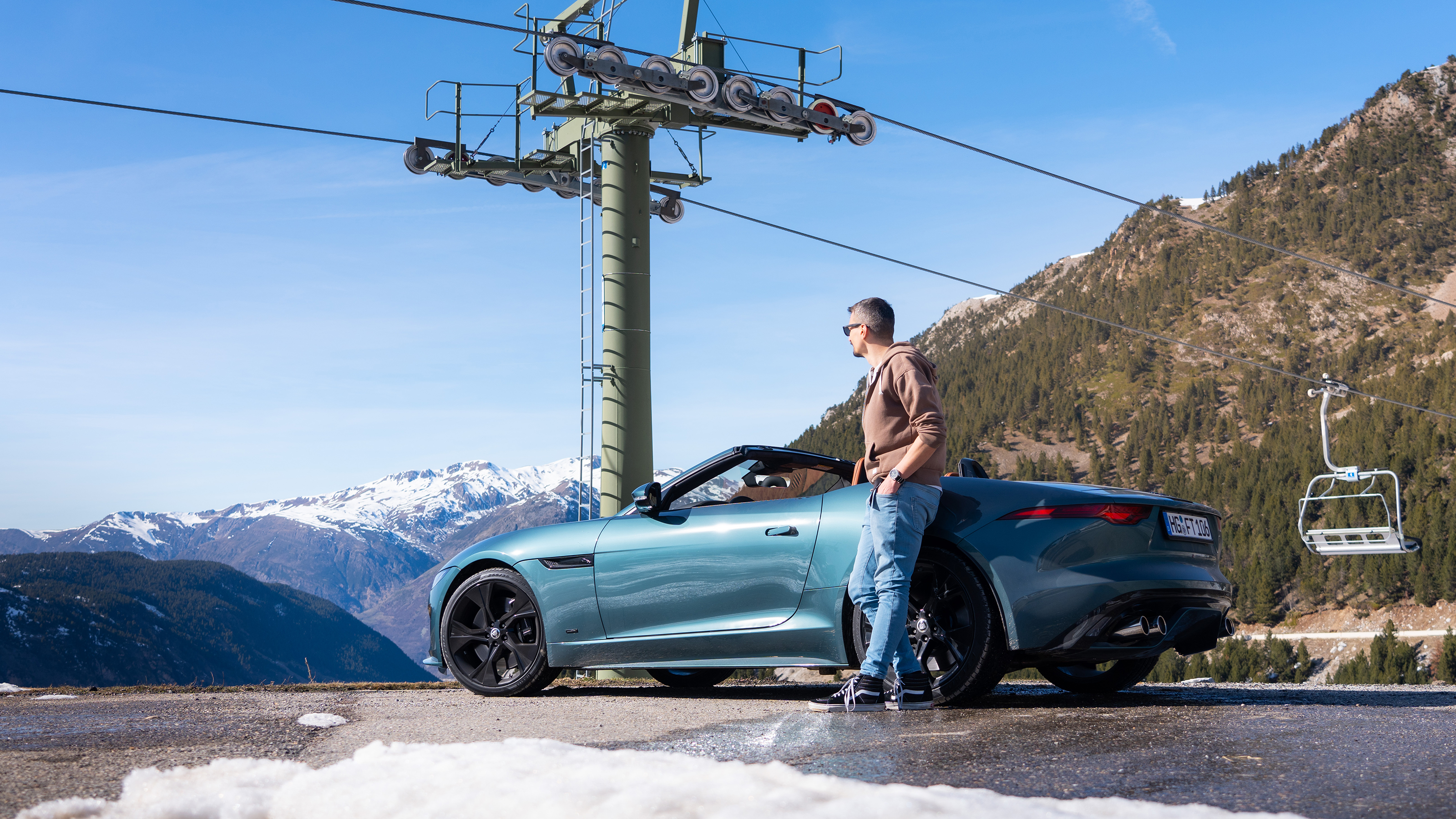 Jaguar F-Type P450 75 - Matt Robinson leaning on car looking at cable car
