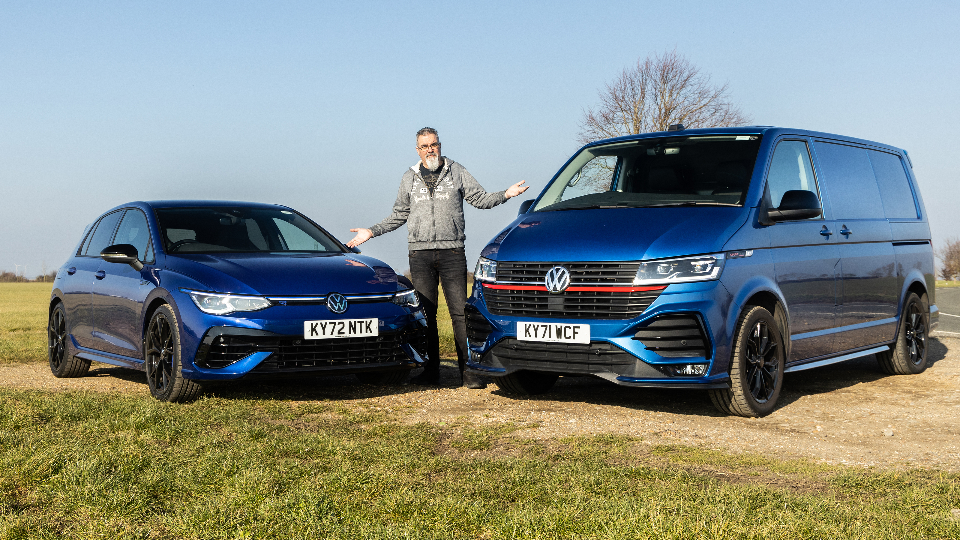 Dean Gibson standing between Volkswagen Golf and Volkswagen Transporter