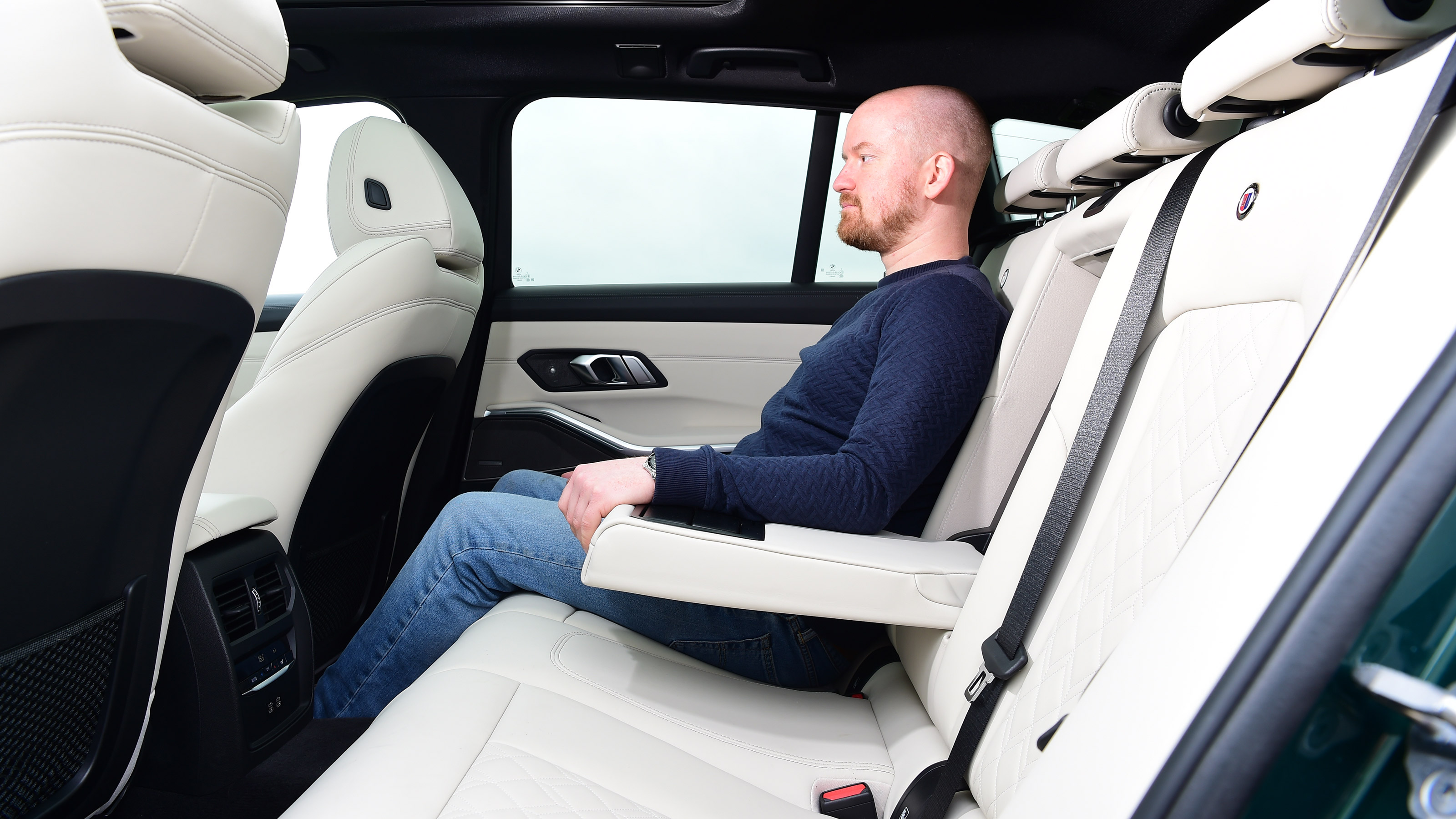 Alex Ingram sat in the back of an Alpina B3 Touring
