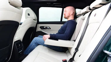 Alex Ingram sat in the back of an Alpina B3 Touring