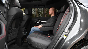 Auto Express chief reviewer Alex Ingram sitting in back seat of Audi Q8 e-tron