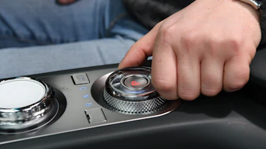 Auto Express chief reviewer Alex Ingram operating Genesis Electrified GV70's gear selector