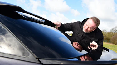 Auto Express Web Producer Pete Baiden inspecting Citroen C5 X rear window