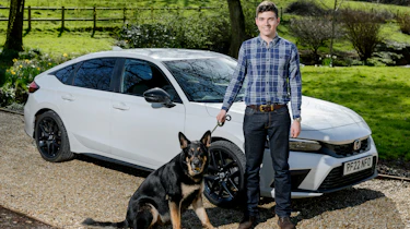 Tristan Shale-Hester and his dog standing in front of the Honda Civic Sport