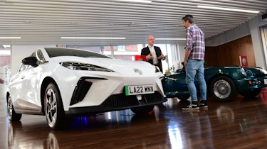 Auto Express deputy executive editor Matt Robinson talking to MG Motor UK head of product and planning systems David Allison with MG4 in foreground