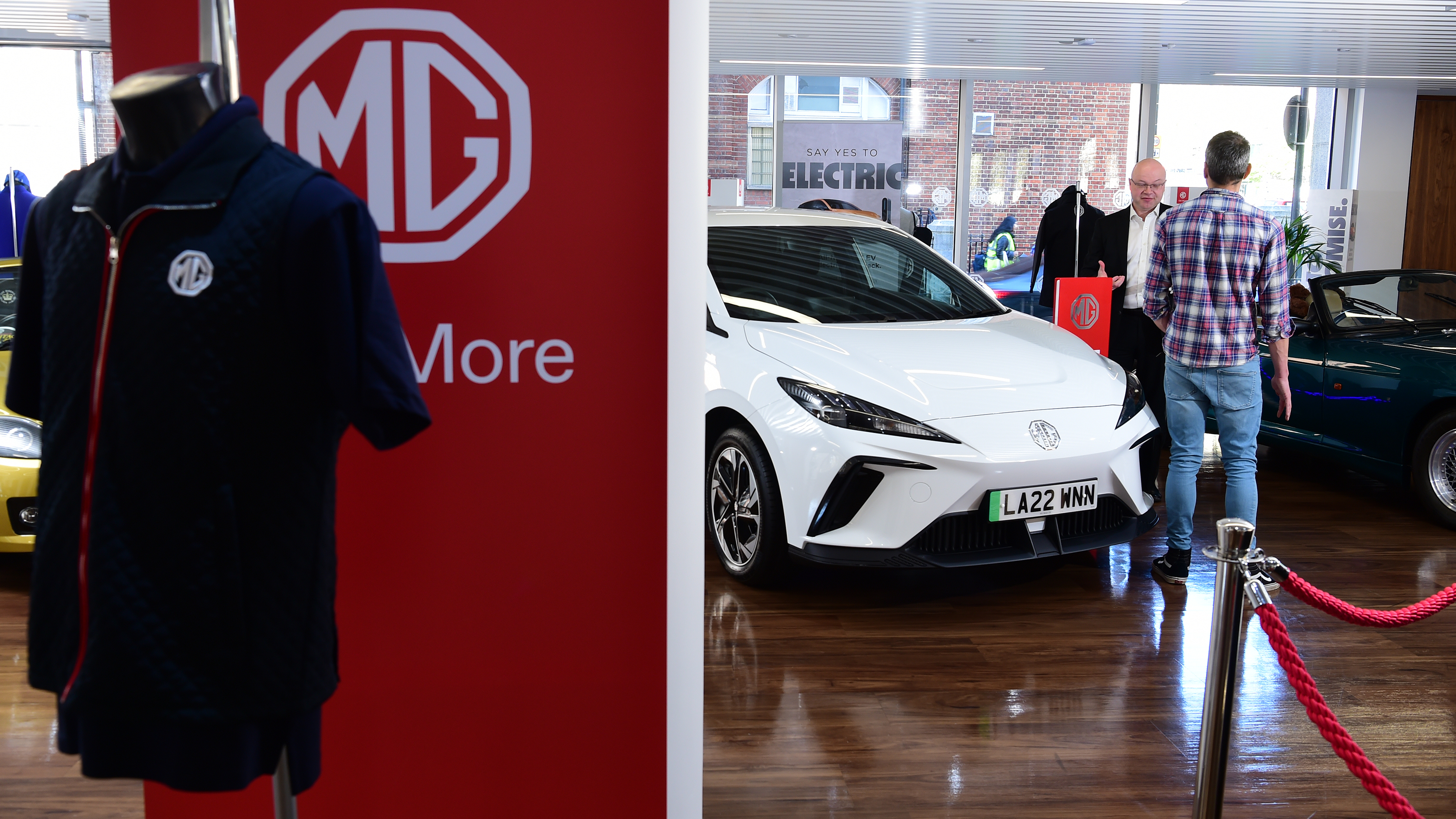 MG-branded jacket hanging on MG sign