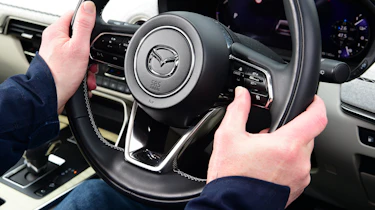 Auto Express chief sub-editor Andy Pringle operating Mazda CX-60 steering wheel controls