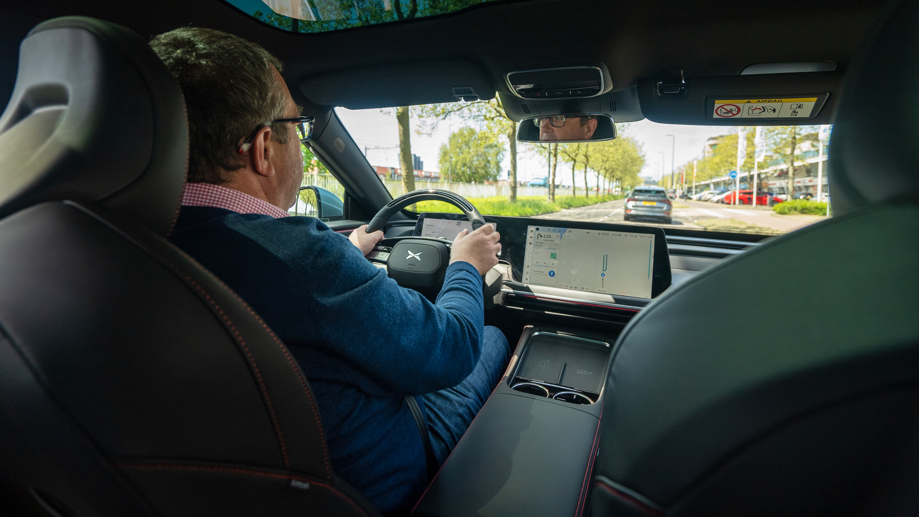 Auto Express deputy editor John McIlroy driving XPeng P7 (over-shoulder view)