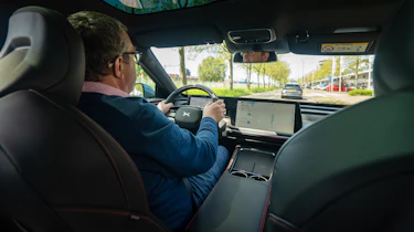Auto Express deputy editor John McIlroy driving XPeng P7 (over-shoulder view)
