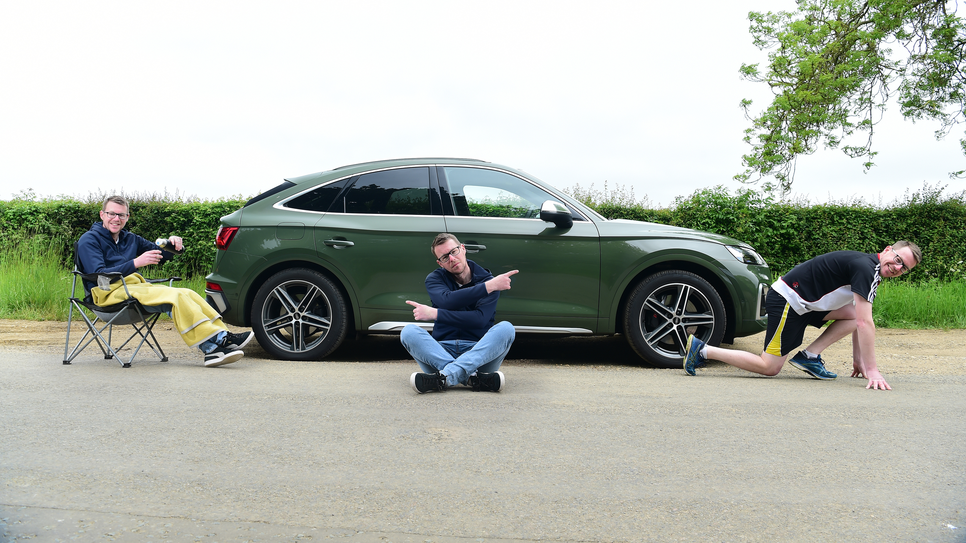Auto Express associate editor Sean Carson striking various poses around the Audi SQ5