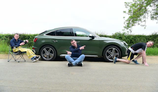 Auto Express associate editor Sean Carson striking various poses around the Audi SQ5
