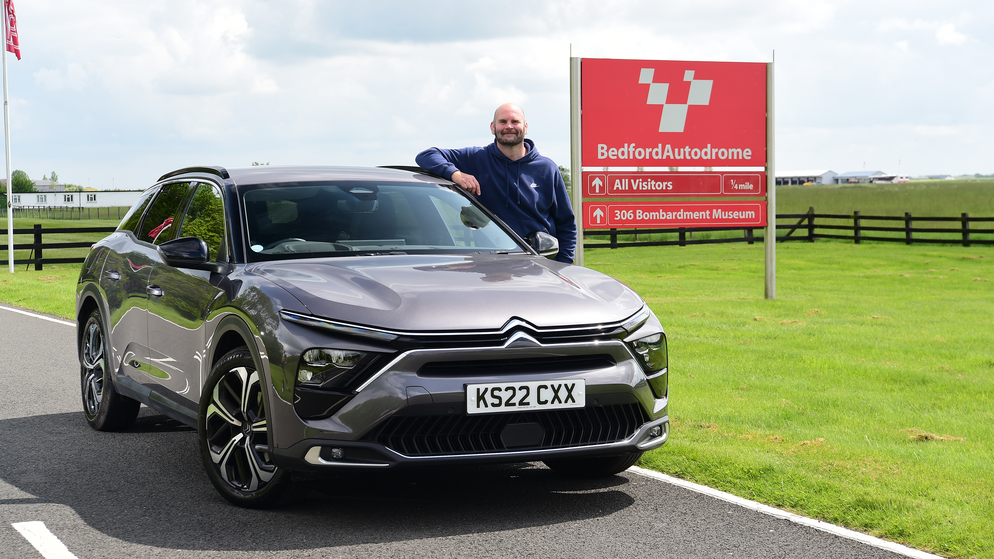 Autovia group automotive art director Darren Wilson standing next to Citroen C5 X outside Bedford Autodrome