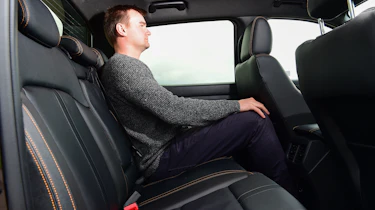 Auto Express staff writer Alastair Crooks sitting in back seat of new Ford Ranger Wildtrak