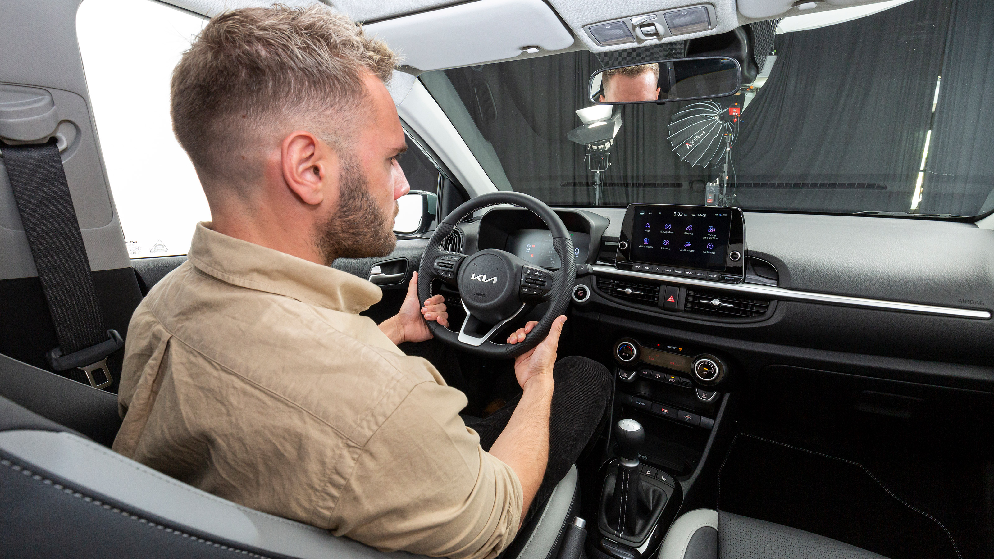 Charlie Harvey sitting inside the Kia Picanto