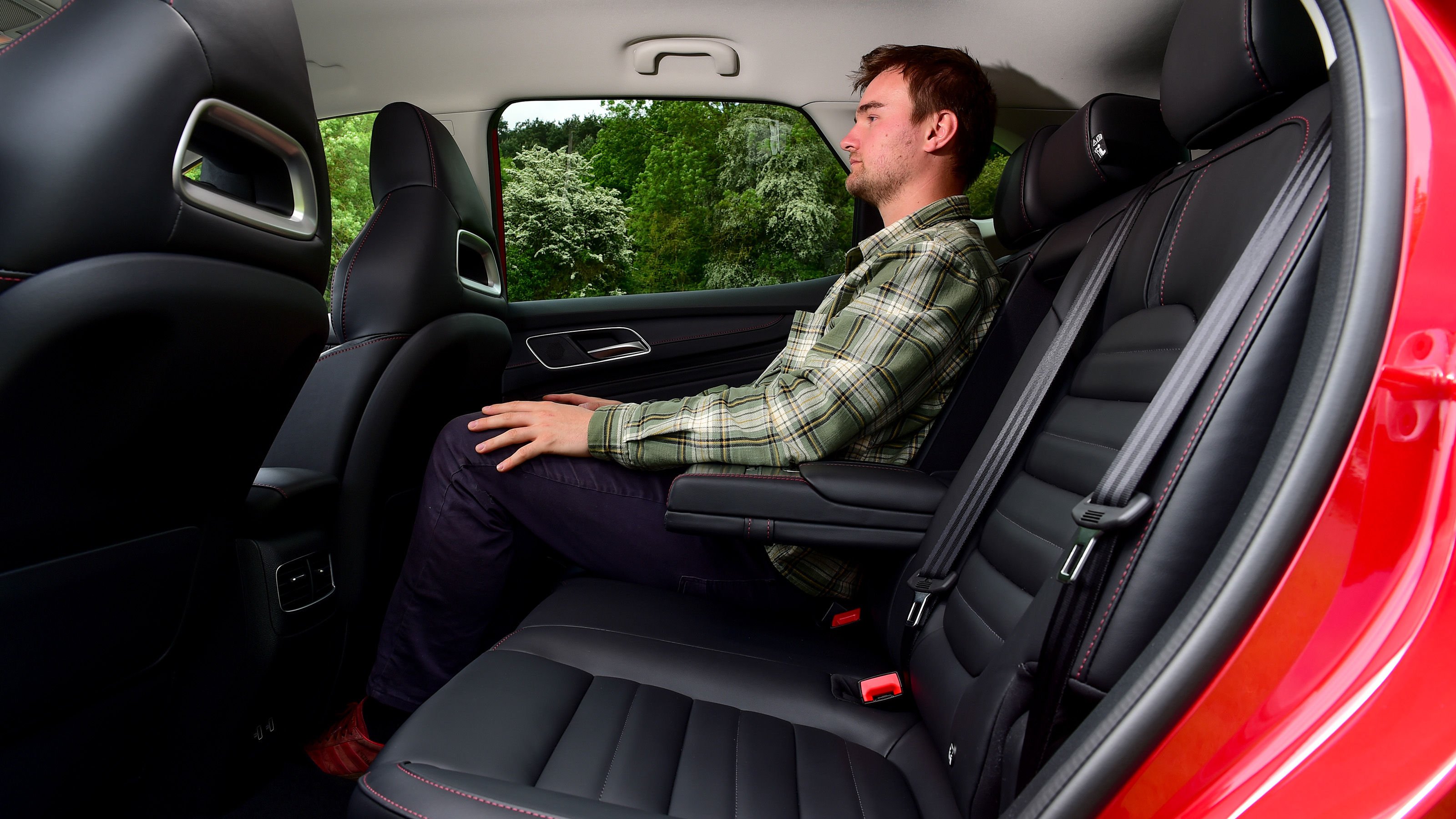 Auto Express staff writer Alastair Crooks sitting in back seat of facelifted MG HS