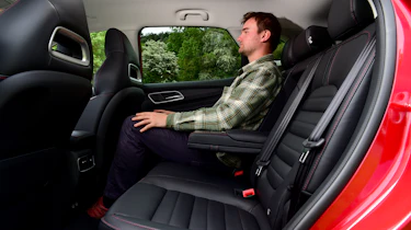 Auto Express staff writer Alastair Crooks sitting in back seat of facelifted MG HS