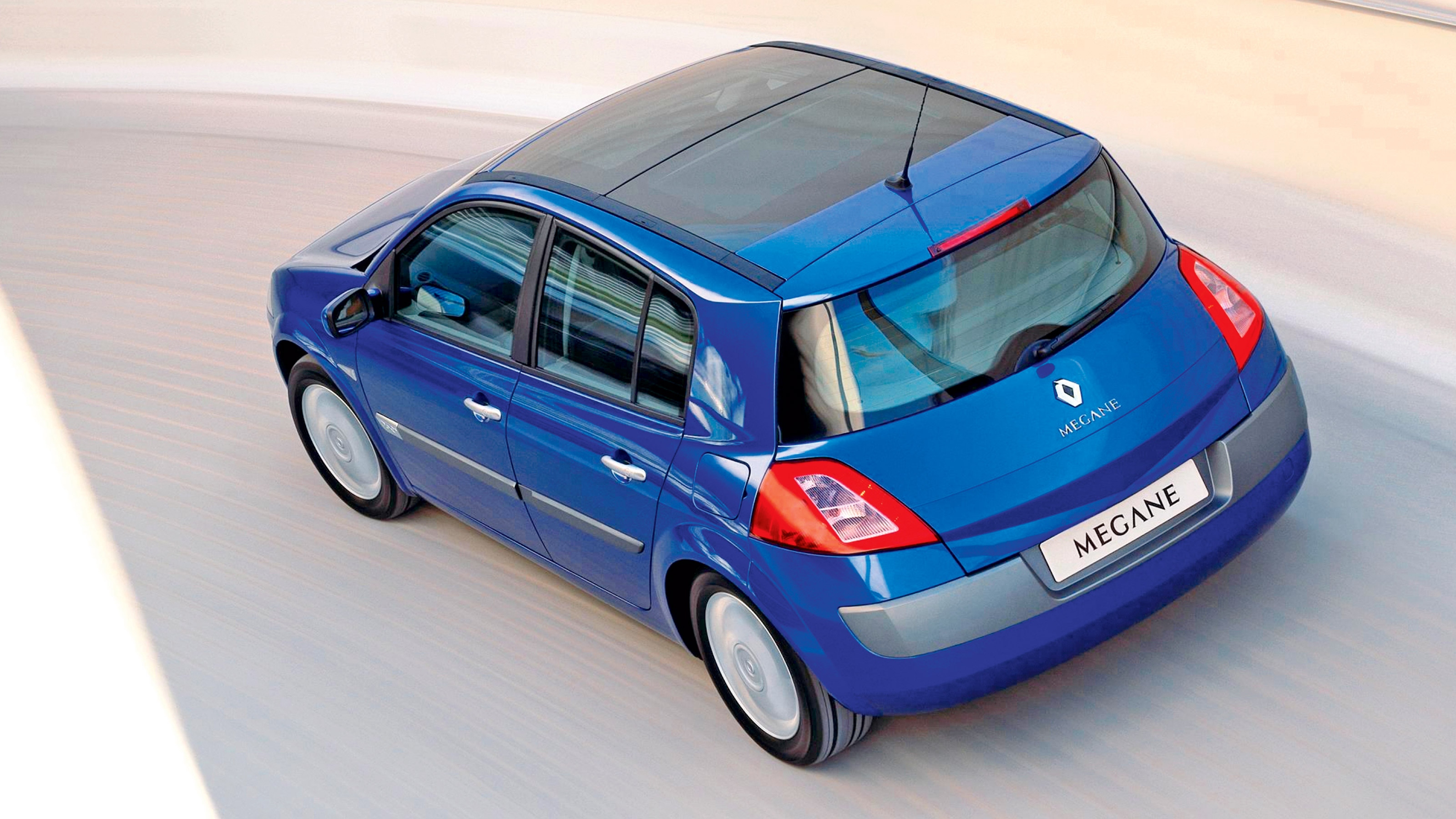 A behind view of a blue Renault Megane.