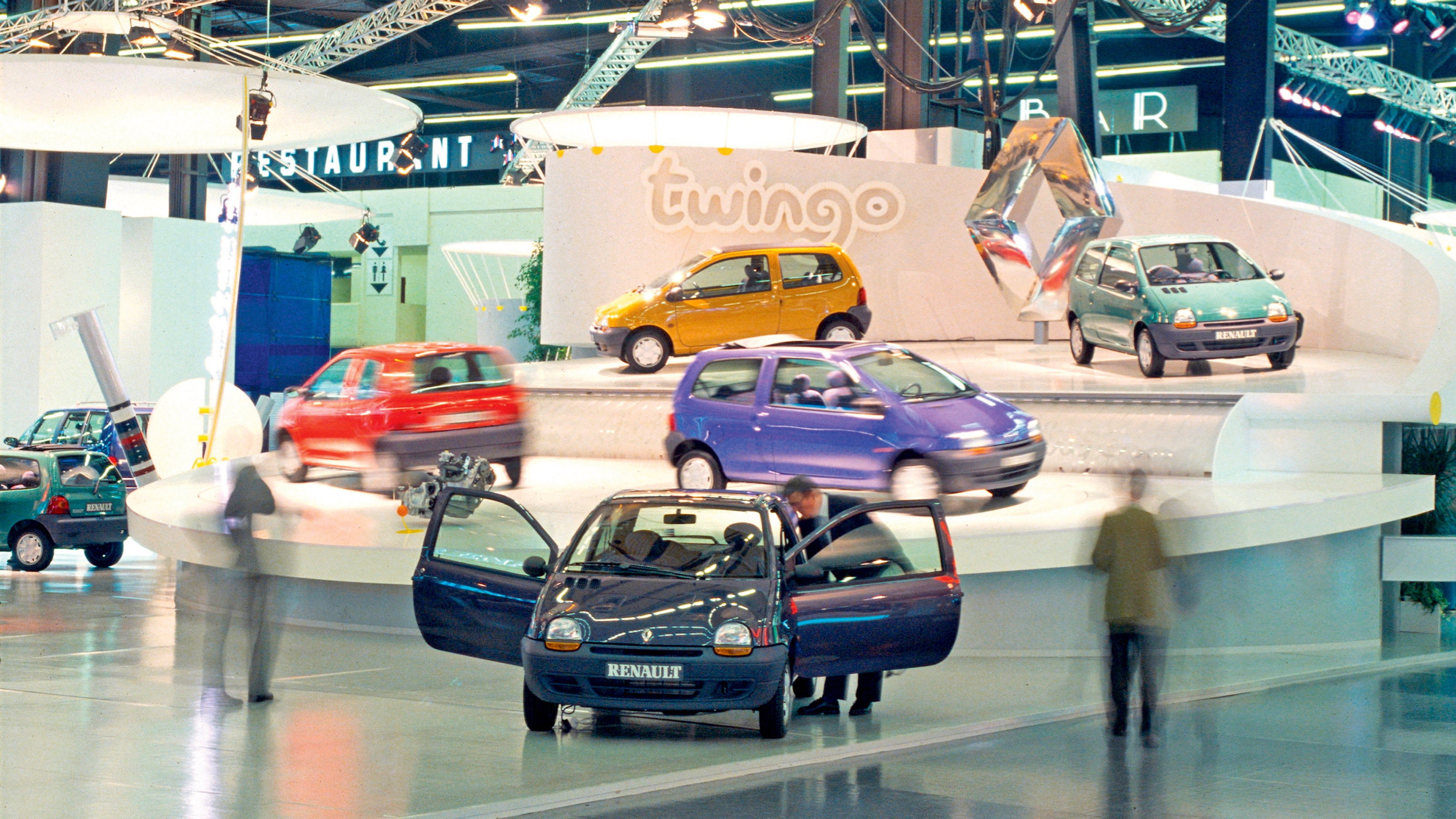 Multiple Renault Twingos in a showroom - front shot.
