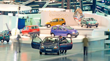 Multiple Renault Twingos in a showroom - front shot.