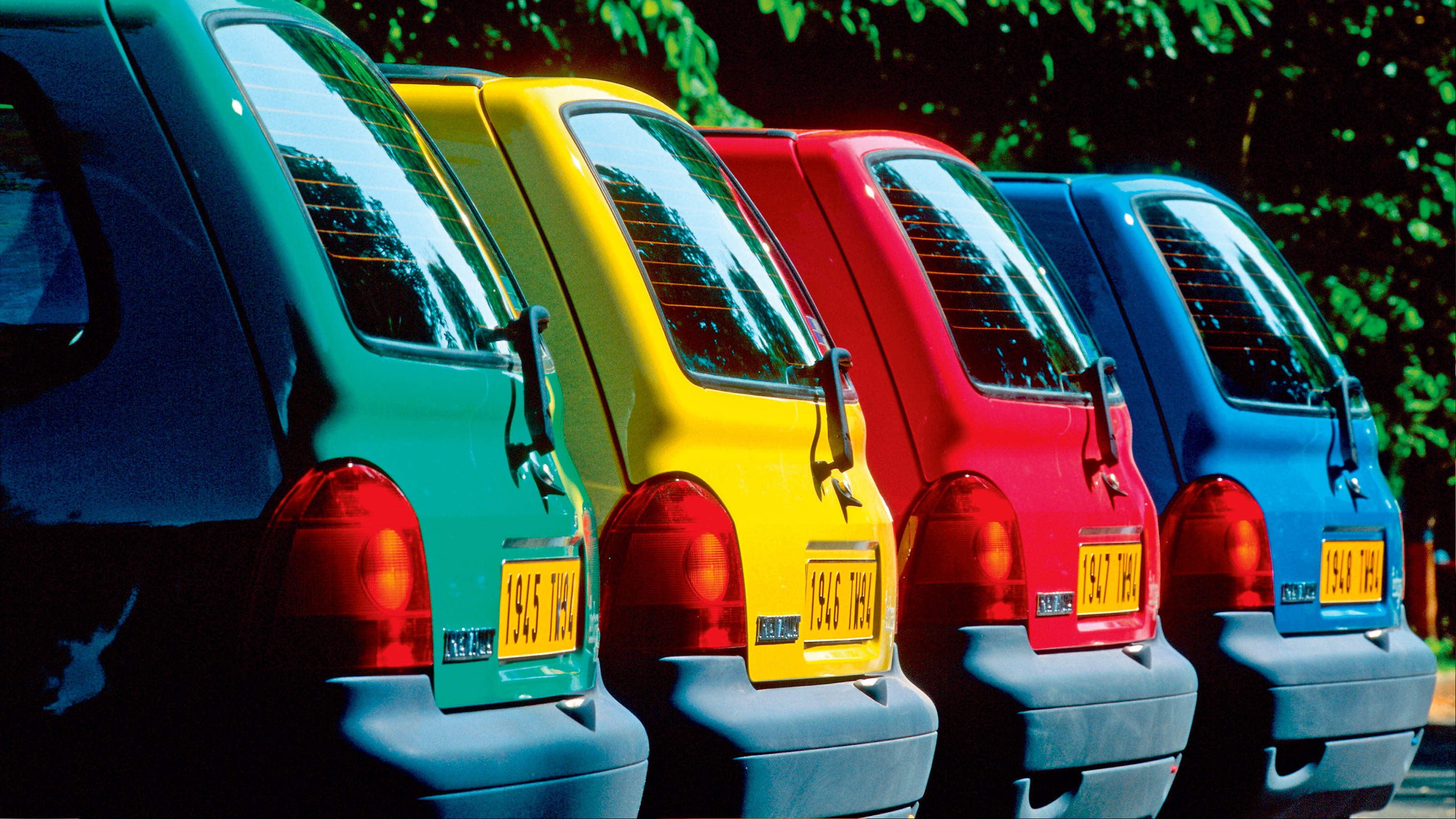 Different Renault Twingos in different colours - side shot.