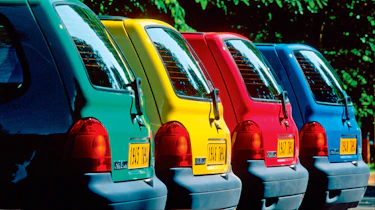 Different Renault Twingos in different colours - side shot.