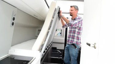 Auto Express deputy executive editor Matt Robinson adjusting Volkswagen Grand California foldaway bed
