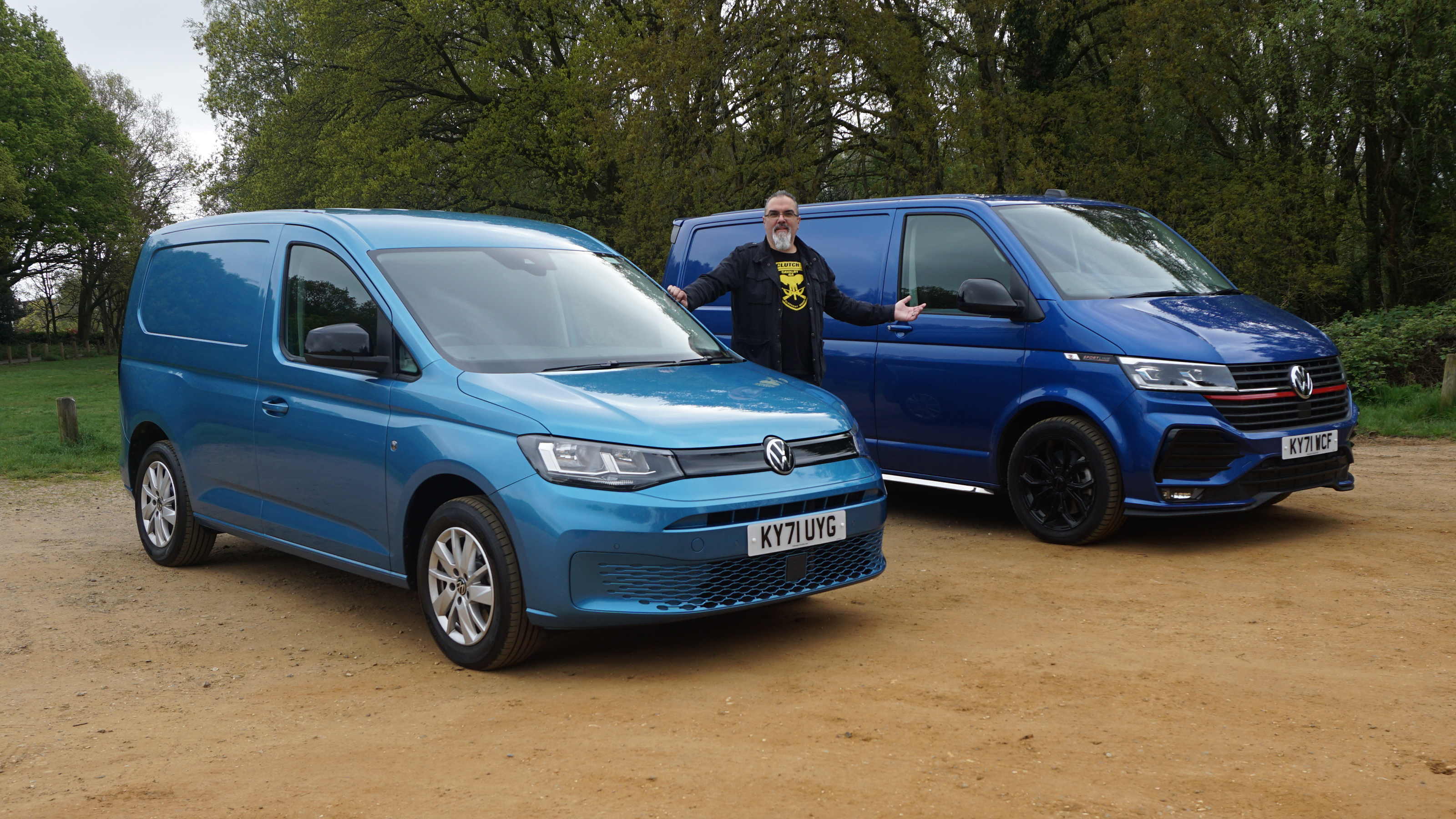 Auto Express senior test editor Dean Gibson standing between the Volkswagen Transporter and Volkswagen Caddy