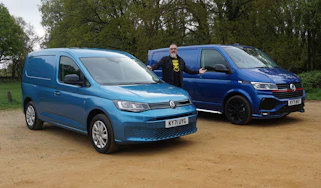 Auto Express senior test editor Dean Gibson standing between the Volkswagen Transporter and Volkswagen Caddy