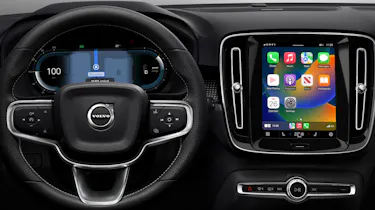 Volvo dashboard with infotainment screen displaying Apple CarPlay homescreen