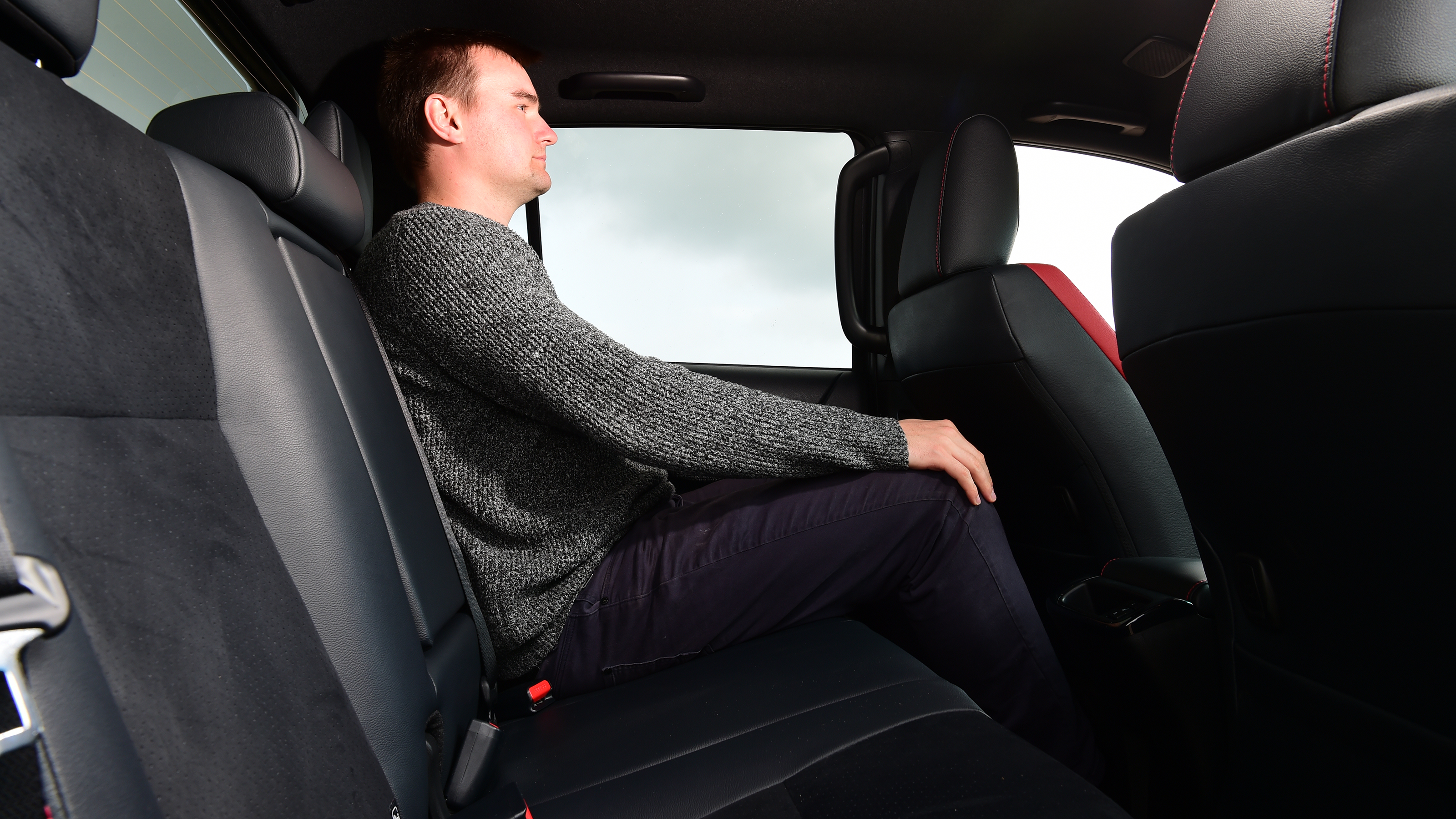 Auto Express senior test editor Dean Gibson sitting in the back of the Toyota Hilux