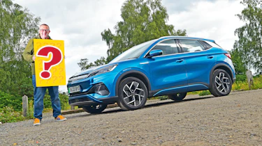 Auto Express deputy editor John McIlroy holding a giant question mark standing next to the BYD Atto 3