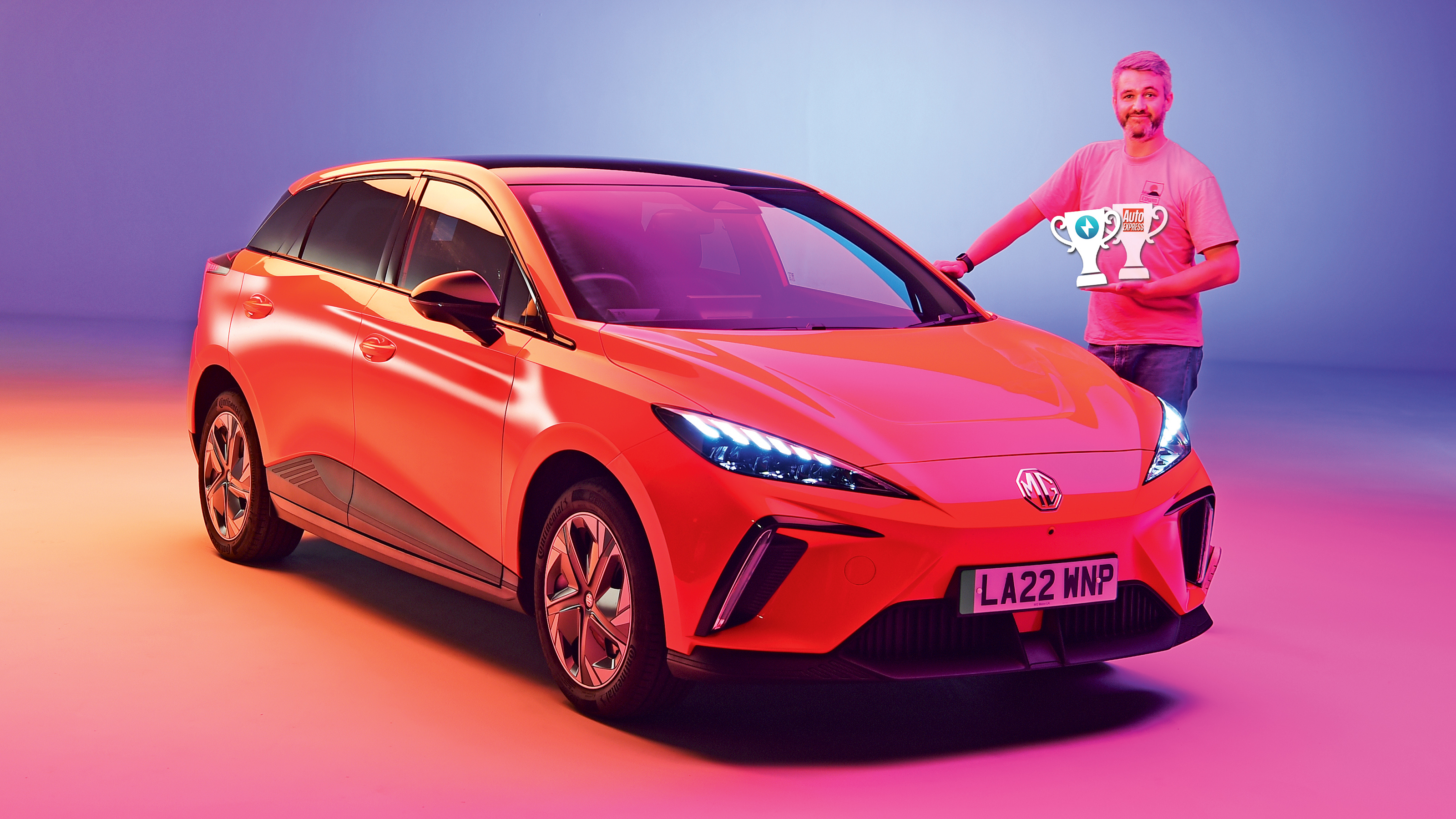 Carbuyer and DrivingElectric editor Richard Ingram standing next to the MG4 at the Auto Express New Car Awards photoshoot