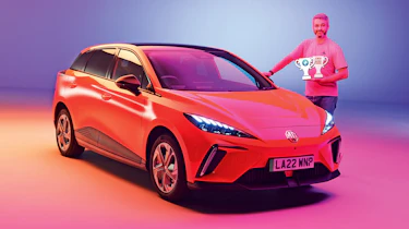 Carbuyer and DrivingElectric editor Richard Ingram standing next to the MG4 at the Auto Express New Car Awards photoshoot