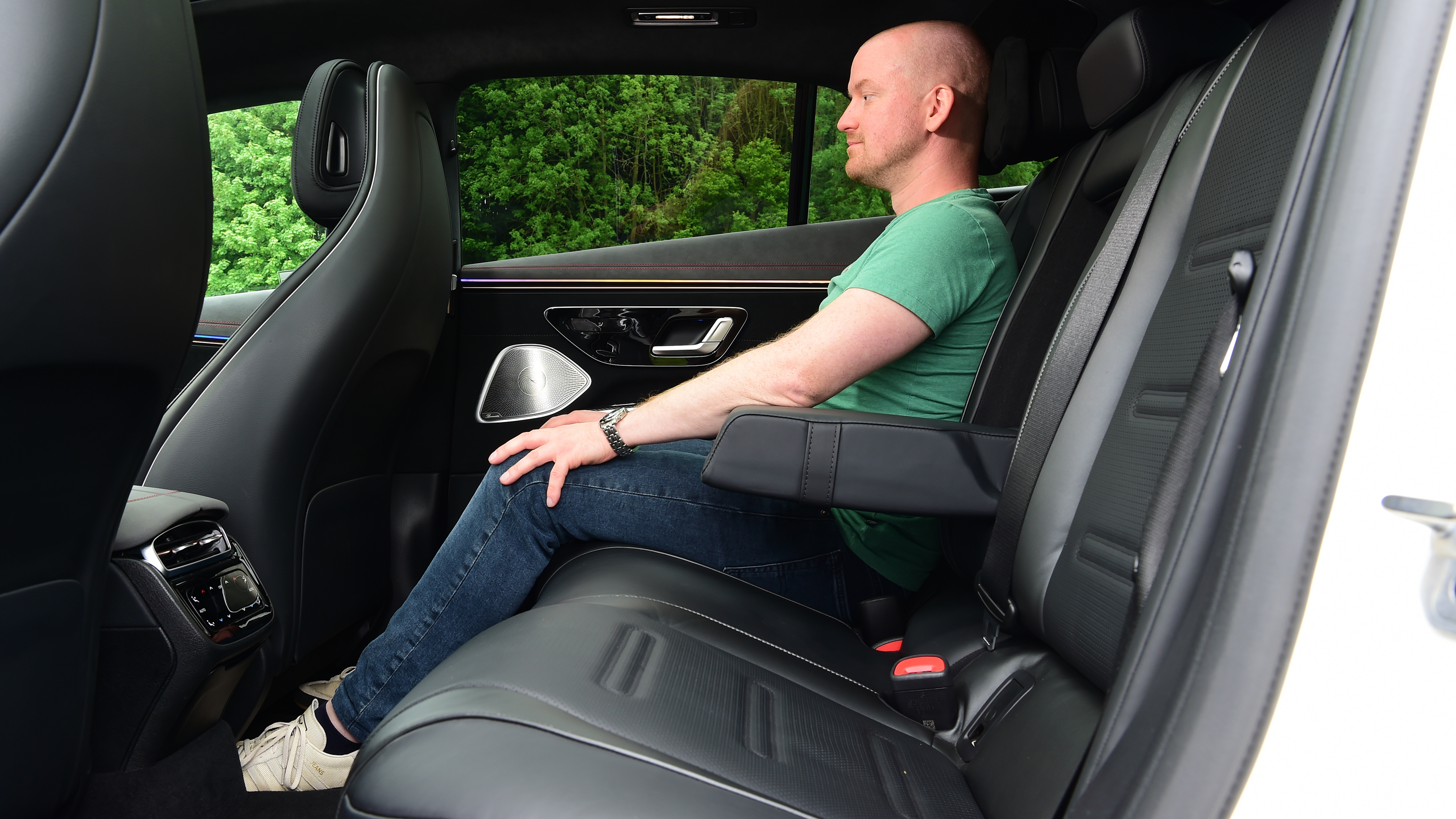 Auto Express chief reviewer Alex Ingram sitting in the back seats of the Mercedes-AMG EQS 35