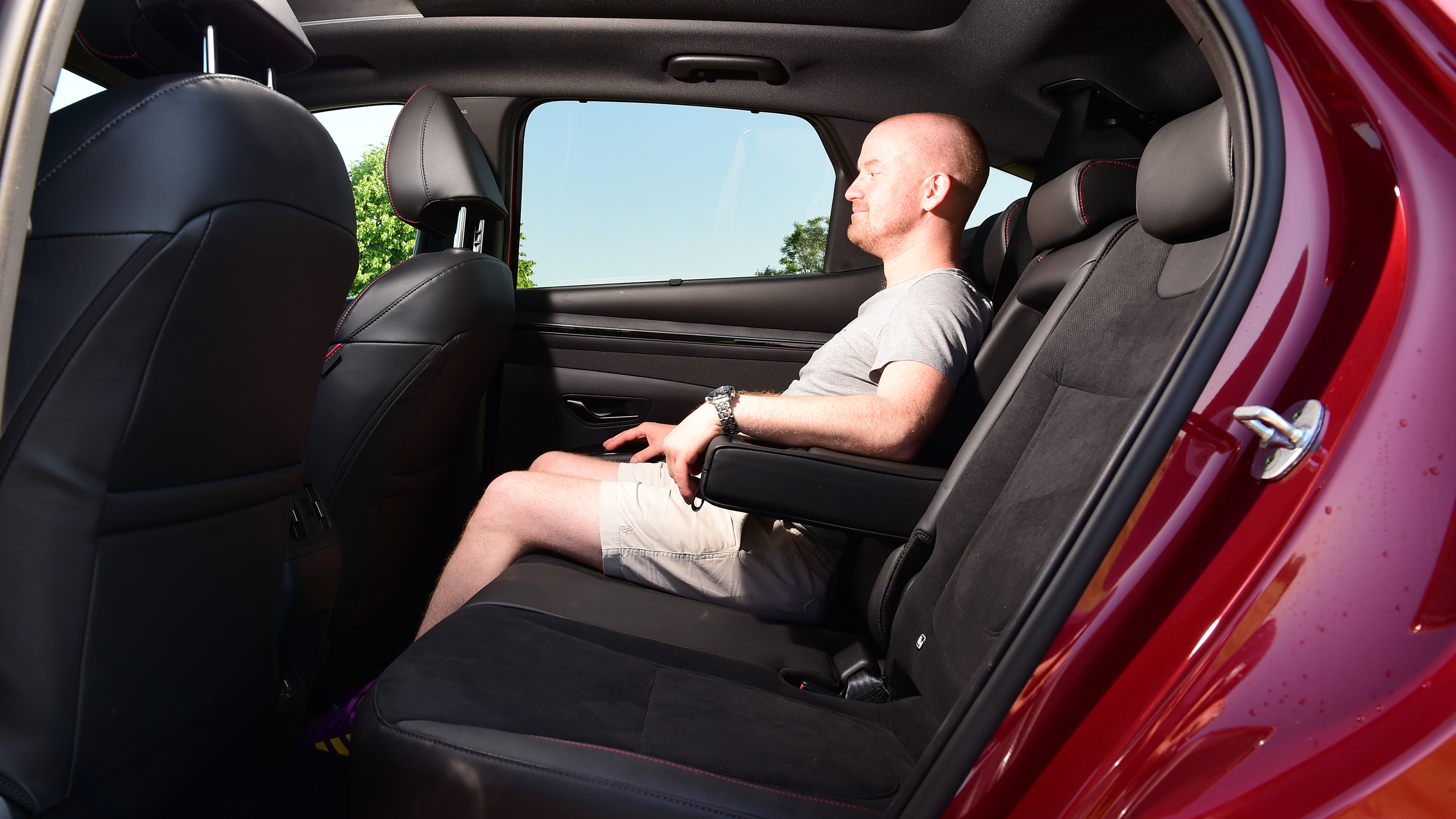 Auto Express chief reviewer Alex Ingram sitting in the back of the Hyundai Tucson