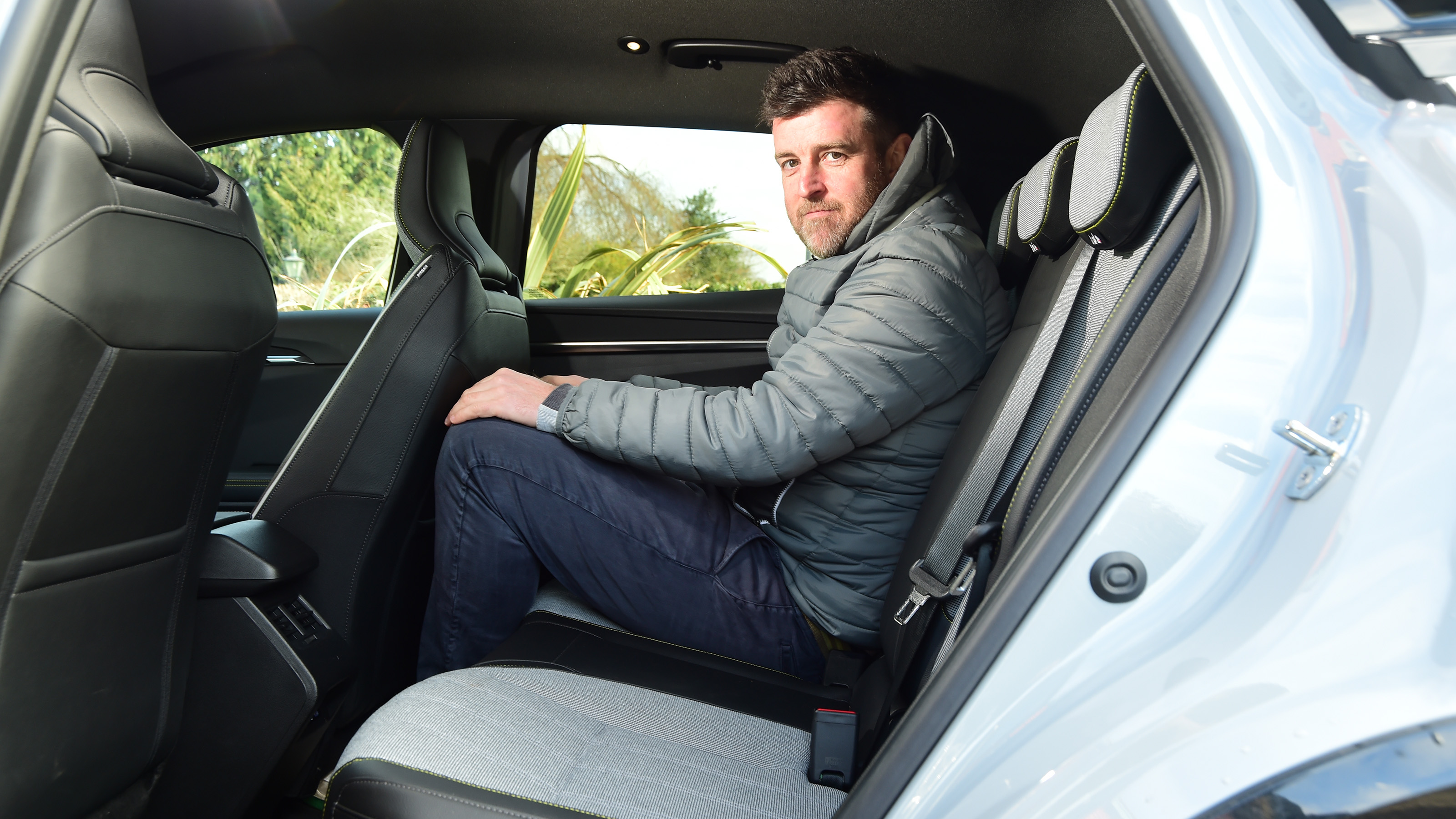Auto Express group web editor Steve Walker sitting in back seat of Renault Megane E-Tech