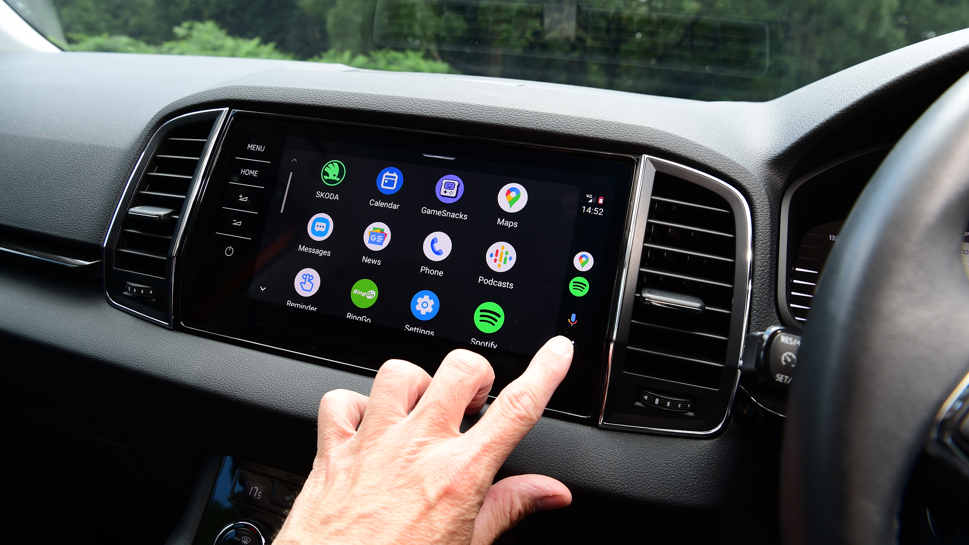 Auto Express staff photographer Pete Gibson operating the Skoda Karoq's infotainment system