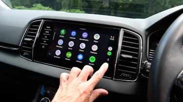 Auto Express staff photographer Pete Gibson operating the Skoda Karoq's infotainment system