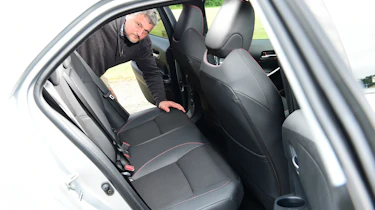 Auto Express current affairs and features editor Chris Rosamond inspecting the Toyota Corolla's back seats