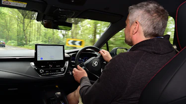 Auto Express current affairs and features editor Chris Rosamond driving the Toyota Corolla