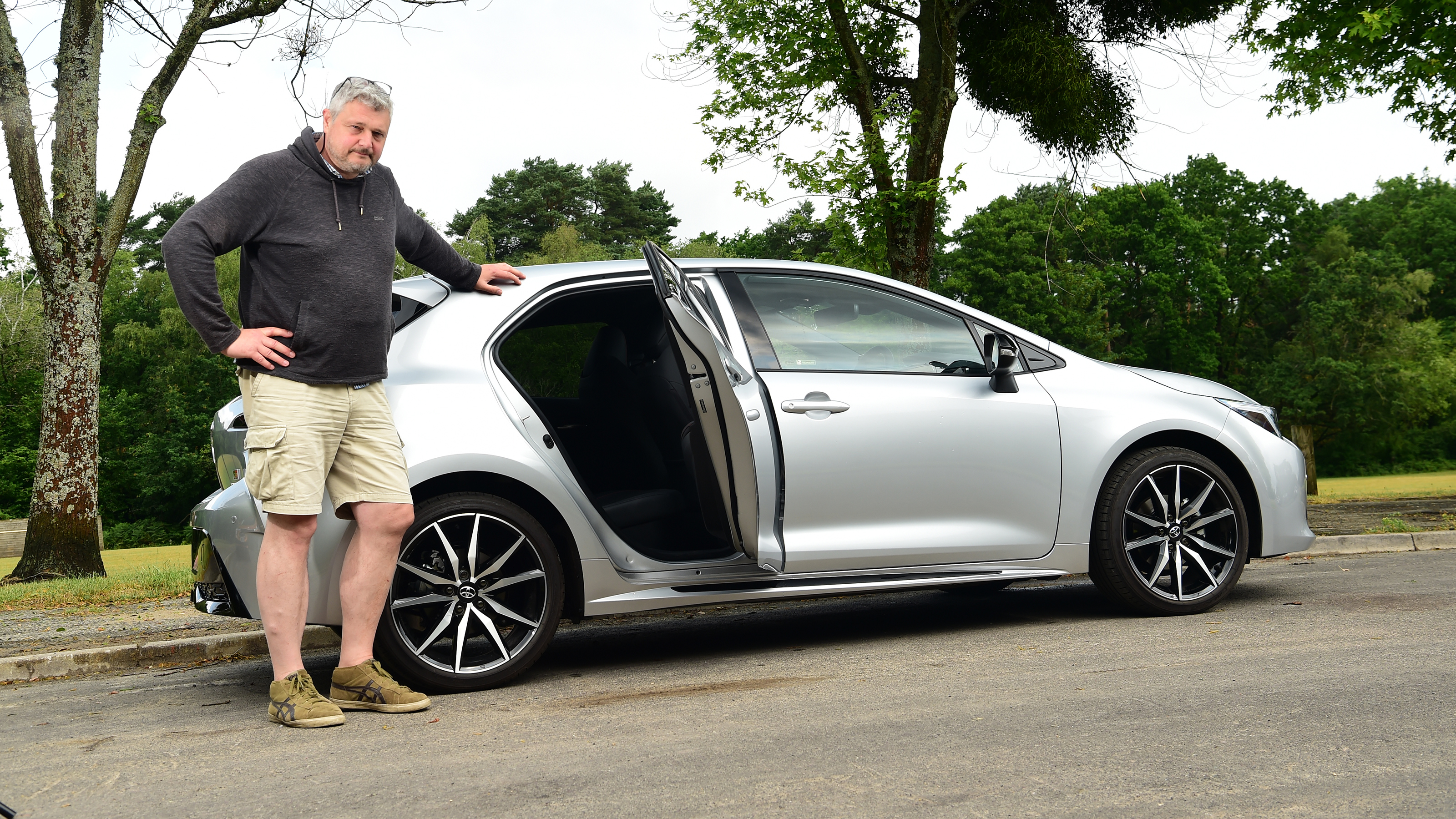 Auto Express current affairs and features editor Chris Rosamond standing with the Toyota Corolla