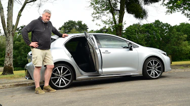 Auto Express current affairs and features editor Chris Rosamond standing with the Toyota Corolla