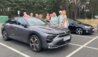 Auto Express creative director Darren Wilson's family standing next to the Citroen C5 X