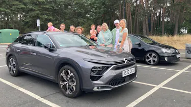 Auto Express creative director Darren Wilson's family standing next to the Citroen C5 X