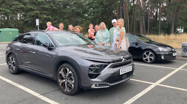 Auto Express creative director Darren Wilson's family standing next to the Citroen C5 X