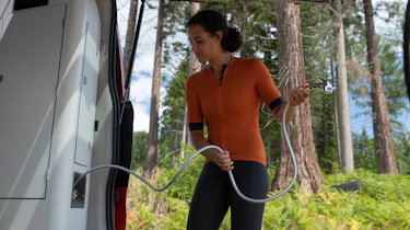 Person using the Ford Transit Custom Nugget's outside shower hose