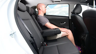Auto Express chief reviewer Alex Ingram sitting in the back seat of the Hyundai Kona Hybrid