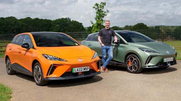 Carbuyer and DrivingElectric editor Richard Ingram standing between the MG4 Trophy and MG4 XPower