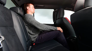 Auto Express staff writer Alastair Crooks sitting in back seat of Toyota Hilux
