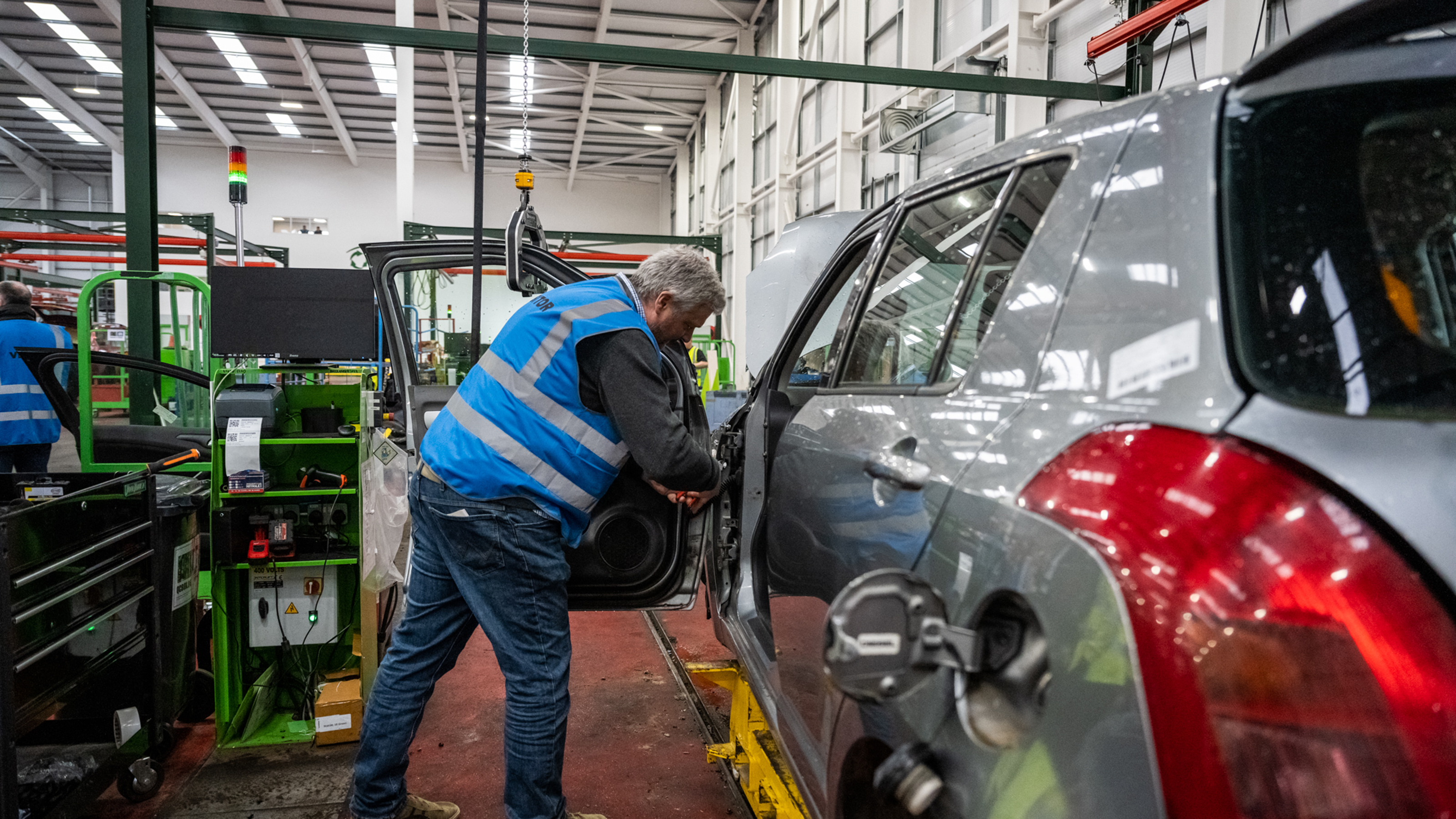 Recycled car parts - car door being removed 